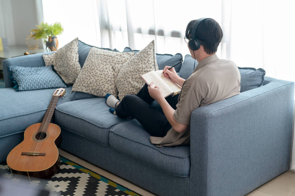 A musician is writing song in home Studio  - Fotó, kép