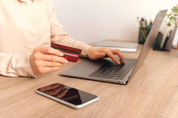Close up photo of woman purchasing something online with credit card. - Photo, Image