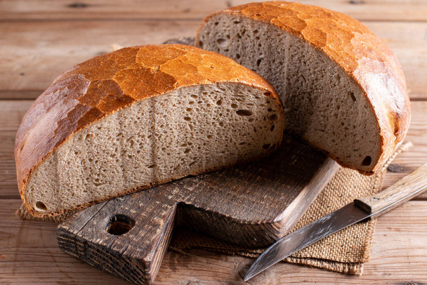 Fresh bread on wooden ground. Freshly baked traditional bread on wooden table. Healthy food - Φωτογραφία, εικόνα