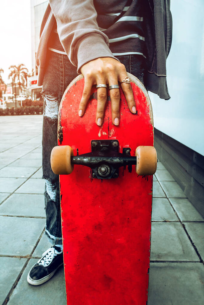Teen with skateboard on the street - 写真・画像