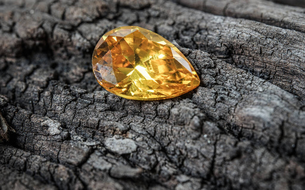 Natural Sapphire gemstone, Jewel or gems on black shine color, natural yellow gemstones on stone - Photo, Image