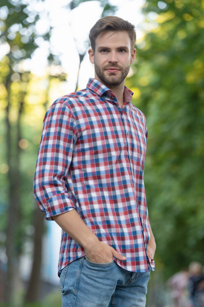 confident young man in checkered shirt outdoor - Fotoğraf, Görsel