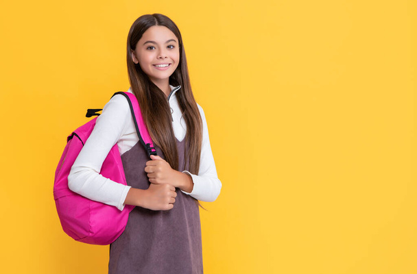 child smile with school backpack on yellow background - Fotó, kép