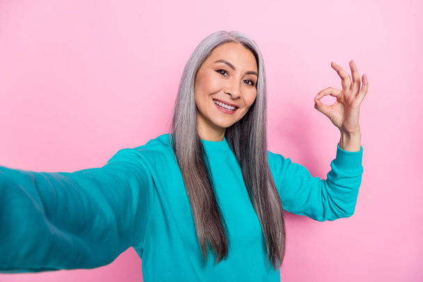 Photo of cheerful lady make selfie demonstrate okey symbol isolated on pink color background - Foto, Imagem