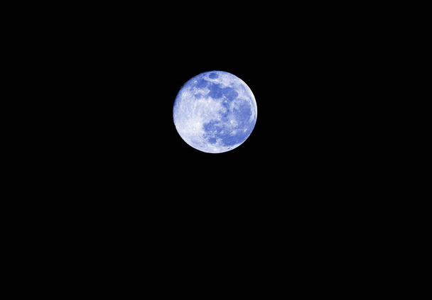 Blue Big full moon on the absolutely black sky at midnight - Photo, image