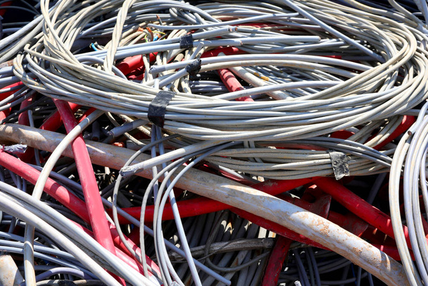 muchos cables eléctricos antiguos utilizados para la distribución de energía eléctrica en hogares ahora depositados en el vertedero de material reciclable - Foto, Imagen