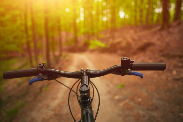 First person view of bicycle handlebar with strong sunlight - Zdjęcie, obraz