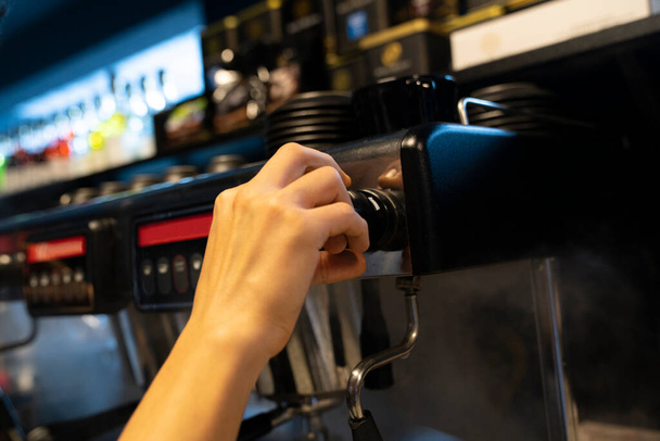 Barista making coffee at an espresso machine - Photo, Image