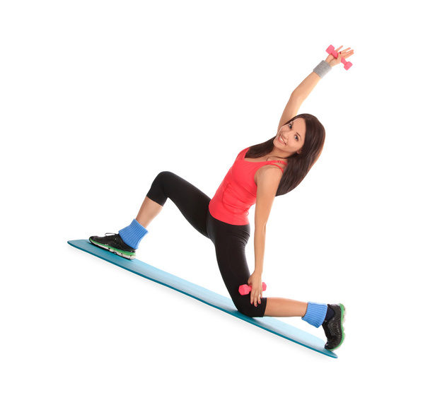 attraktive junge Frau mit Fitnesshanteln im Stretching - Foto, Bild