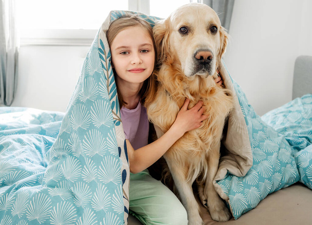 Little girl with golden retriever dog - Fotó, kép