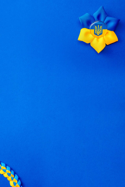 Yellow blue background. Ukrainian flower trident symbol isolated on blue. Support Ukraine concept - Foto, imagen