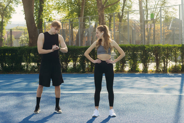 Portrait young sportive couple, in sportswear, doing sports exercises outdoors, sport, healthy lifestyle - Φωτογραφία, εικόνα