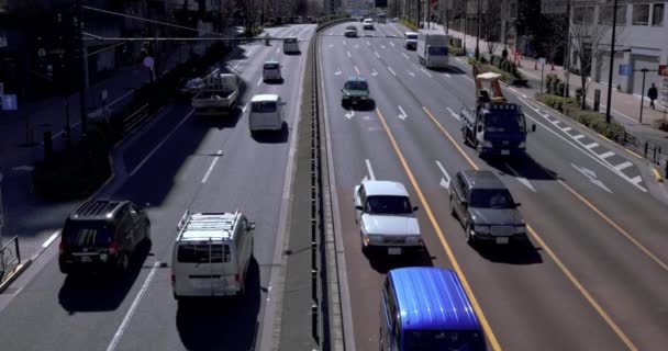 Cars come ang go at Tomigaya crossing in Tokyo high angle - Footage, Video
