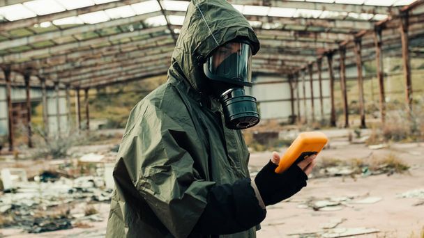 man with geiger counter in radioactive site - Foto, Imagen
