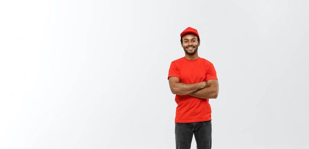 Delivery Concept - Handsome African American delivery man crossed arms over isolated on Grey studio Background. Copy Space. - Foto, immagini
