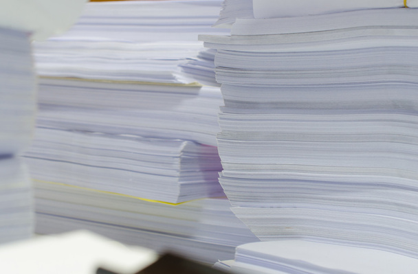 Pile of documents on desk stack up high waiting to be managed - Photo, Image