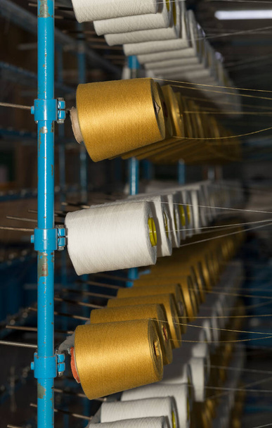 An old textile manufactory. Textile manufacturing. The work of textile processing machines. - Fotó, kép