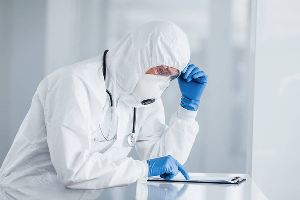 Male doctor scientist in lab coat, defensive eyewear and mask. - Photo, image