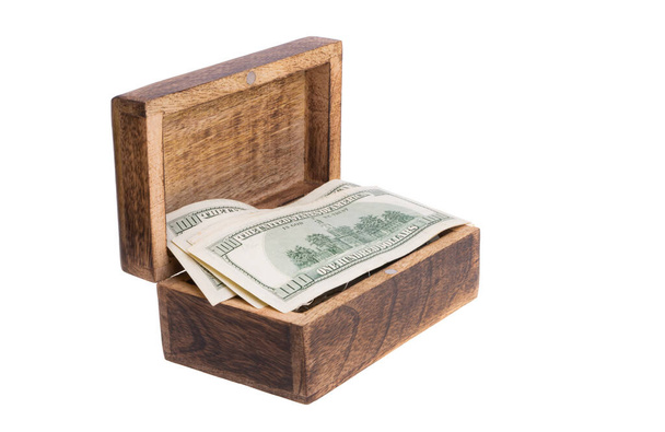 dollars in a wooden box isolated on a white background - Foto, Bild