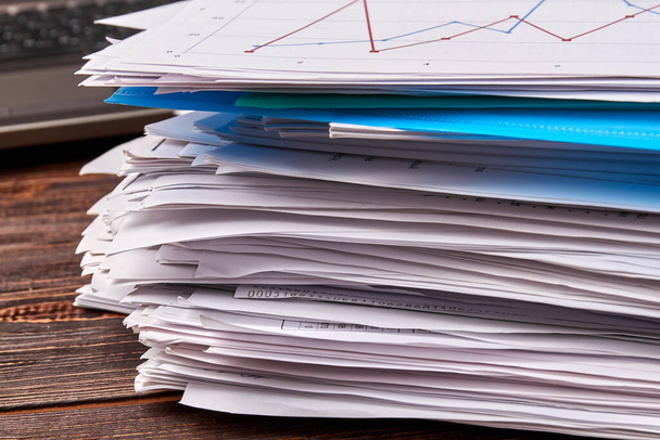 Close-up stack of office work papers on wooden desk. - Foto, imagen