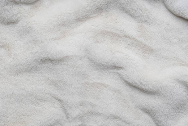 Texture of faux fur. Empty place for text, quote or sayings. Top view. Closeup. Light fur background. - 写真・画像