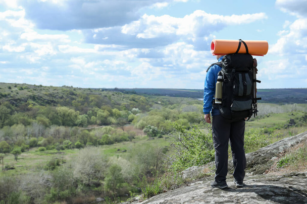 Hiker with backpack ready for journey on rocky hill, back view - Fotoğraf, Görsel