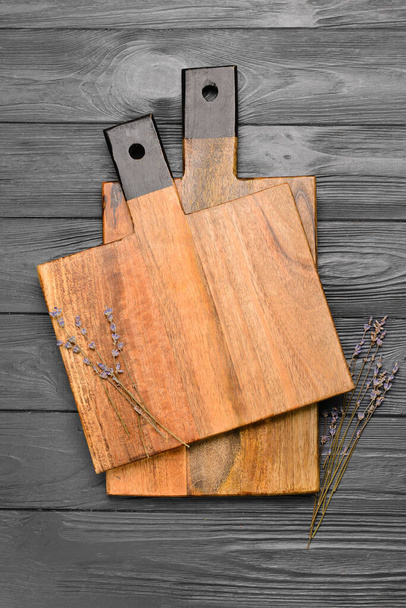 Cutting boards and lavender flowers on grey wooden background - Fotó, kép