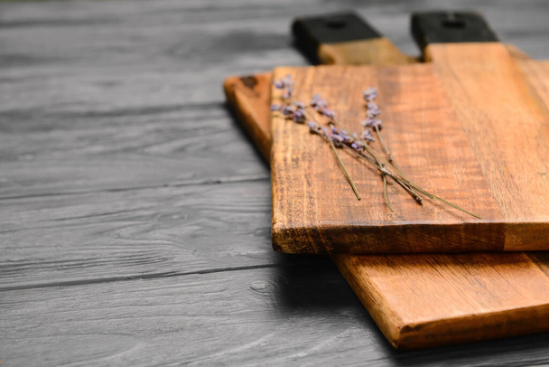 Cutting boards and lavender flowers on grey wooden background, closeup - Fotó, kép