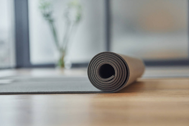Close up detailed view of fitness mat that lying down on the floor. - Photo, image