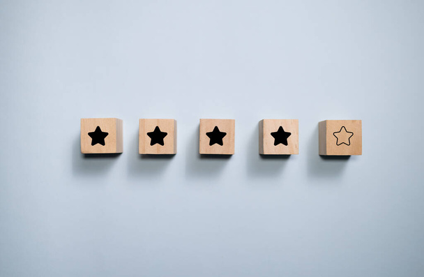 Top view wooden blocks with star rating graphic. Concept for rating and customer satisfaction. - Valokuva, kuva