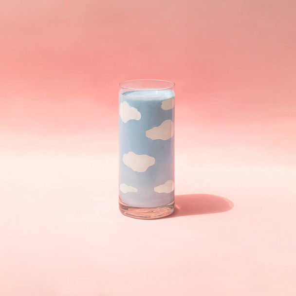 Sky and clouds in glass on pastel light pink background. Creative dream concept. Minimalistic beverage composition with copy space. - Φωτογραφία, εικόνα