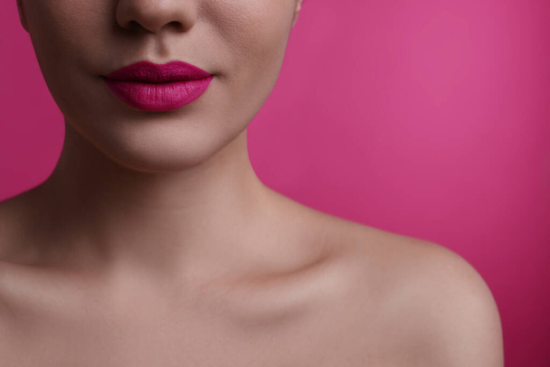 Closeup view of woman with beautiful full lips on pink background - Photo, Image