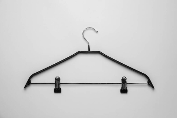 Empty hanger with clips on light grey background, top view - Zdjęcie, obraz
