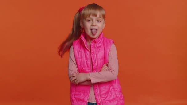 Funny girl kid showing tongue making faces at camera, fooling around, joking, aping with silly face - Imágenes, Vídeo