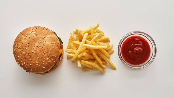 Top view of burger, french fries and sauce - Photo, image