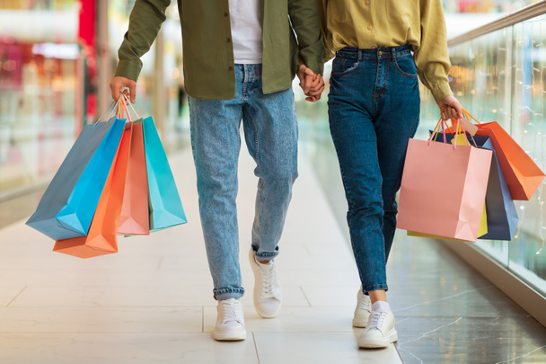 Couple Shopping Carrying Colorful Shopper Bags Walking In Mall, Cropped - Foto, Bild