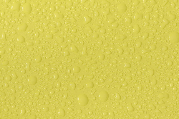 Water droplets on a colored texture. Decorative texture with water drops. - Valokuva, kuva