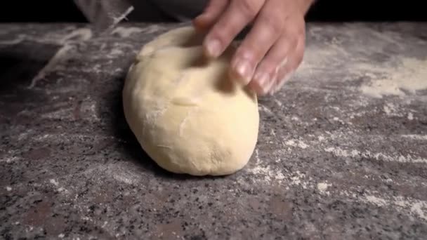 Men's hands hold dough. making raw dough for pizza, rolls or bread. - Video, Çekim