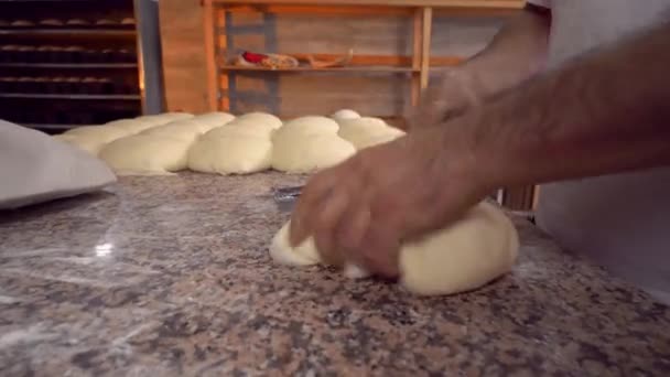 Men's hands hold dough. making raw dough for pizza, rolls or bread. - Imágenes, Vídeo