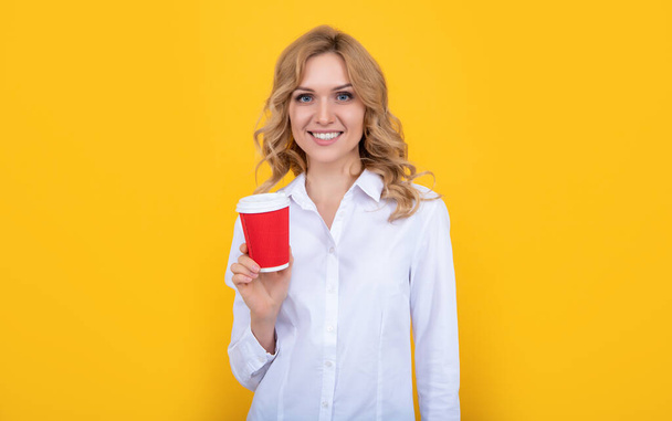 cheerful blonde woman with coffee cup on yellow background - Fotografie, Obrázek