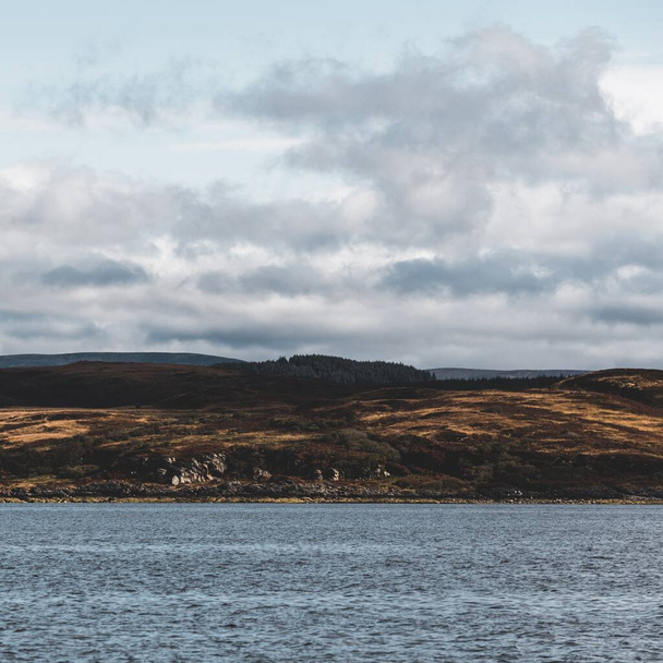 Panoramic view of the rocky shores of Tarbert under dramatic sky. Scotland, UK. Travel destinations, national landmark, recreation, eco tourism, vacations, adventure, exploring - Photo, Image