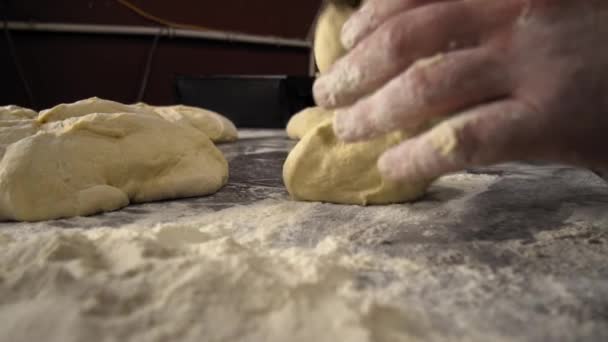 Чоловічі руки тримають тісто. виготовлення сирого тіста для піци, рулетів або хліба
. - Кадри, відео