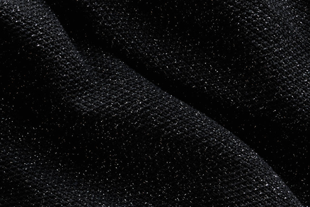 Black background with dark wavy fabric. Black fabric pattern - Foto, Bild