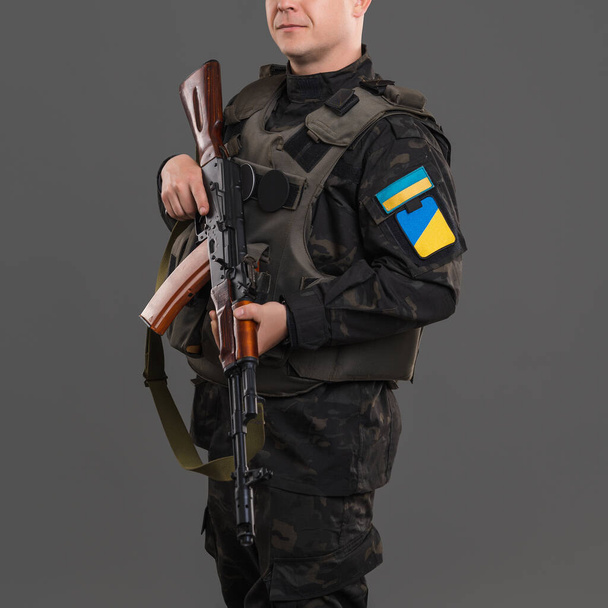 Ukrainian soldier in uniform and with weapons in his hands - Photo, image