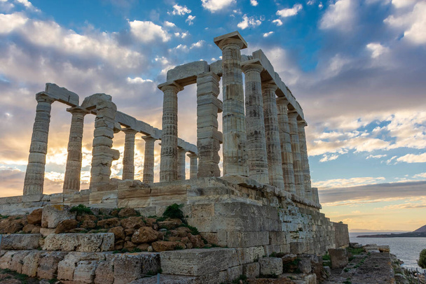 The Temple of Poseidon at Cape Sounion at sunset, over the Aegean Sea in Greece - Photo, image