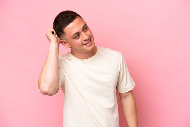 Young Brazilian man isolated on pink background thinking an idea - Photo, Image
