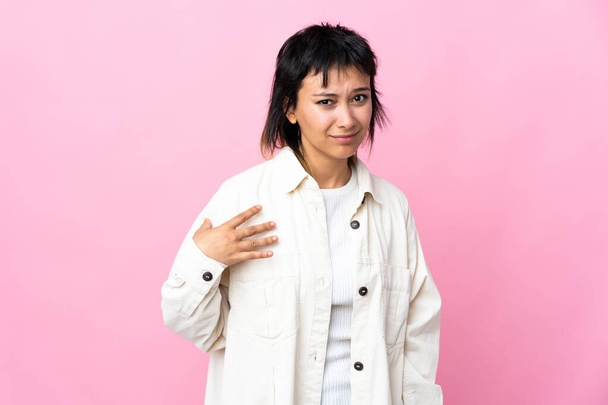 Young Uruguayan woman over isolated pink background pointing to oneself - 写真・画像