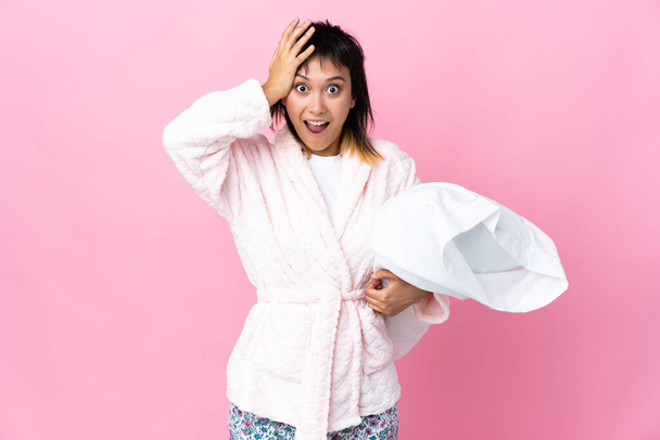 Young Uruguayan woman in pajamas over isolated pink background with surprise facial expression - Photo, Image