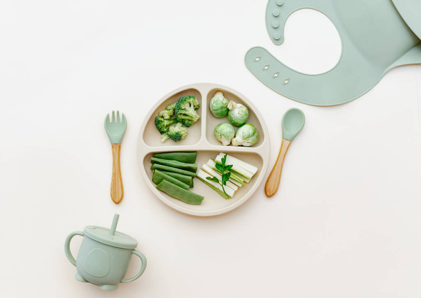 Baby food flat lay. Variation of fresh green vegetables. Healthy vegan food with vitamins, minerals. First children feeding concept. Top view - Foto, immagini