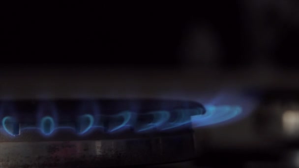 Gas stove being turned on by a lit burner. Natural gas concept. - Кадри, відео